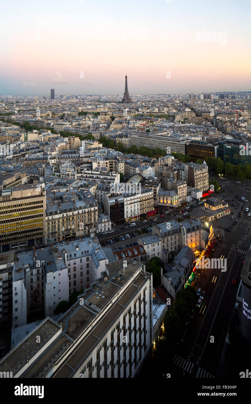 Elevated view of Eiffel Tower, dusk city skyline and distant La Defence skyscraper, Paris, France, Europe Stock Photo