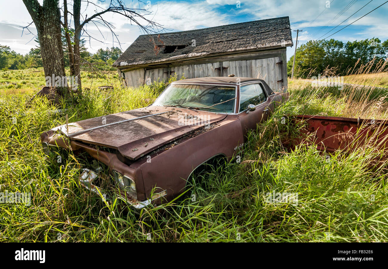 old wrecking car in countryside in Maine, Usa Stock Photo