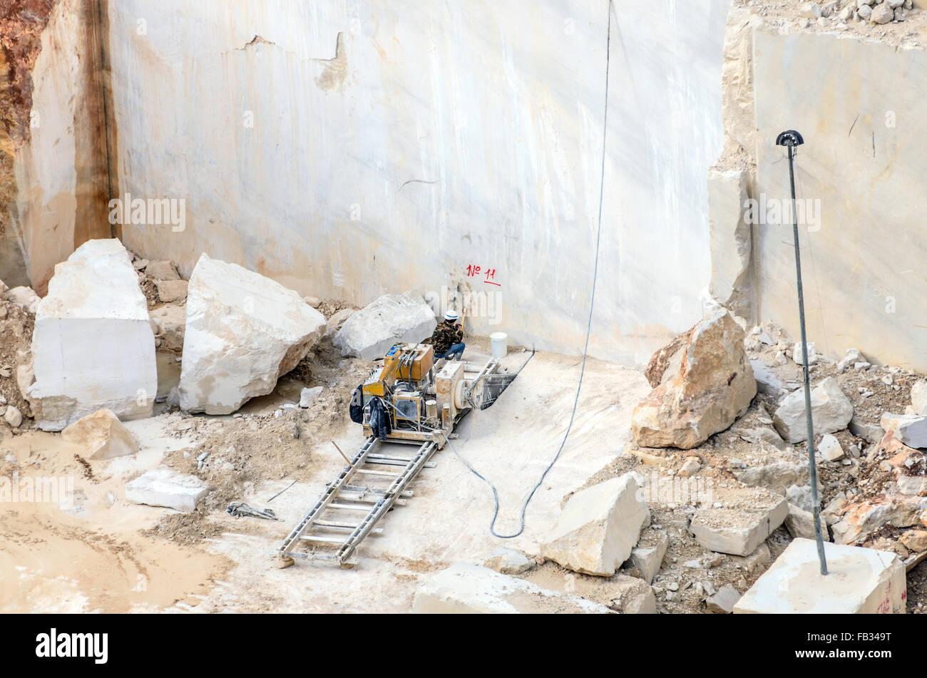 industrial marble quarry with cut blocks and workers and machines FB349T