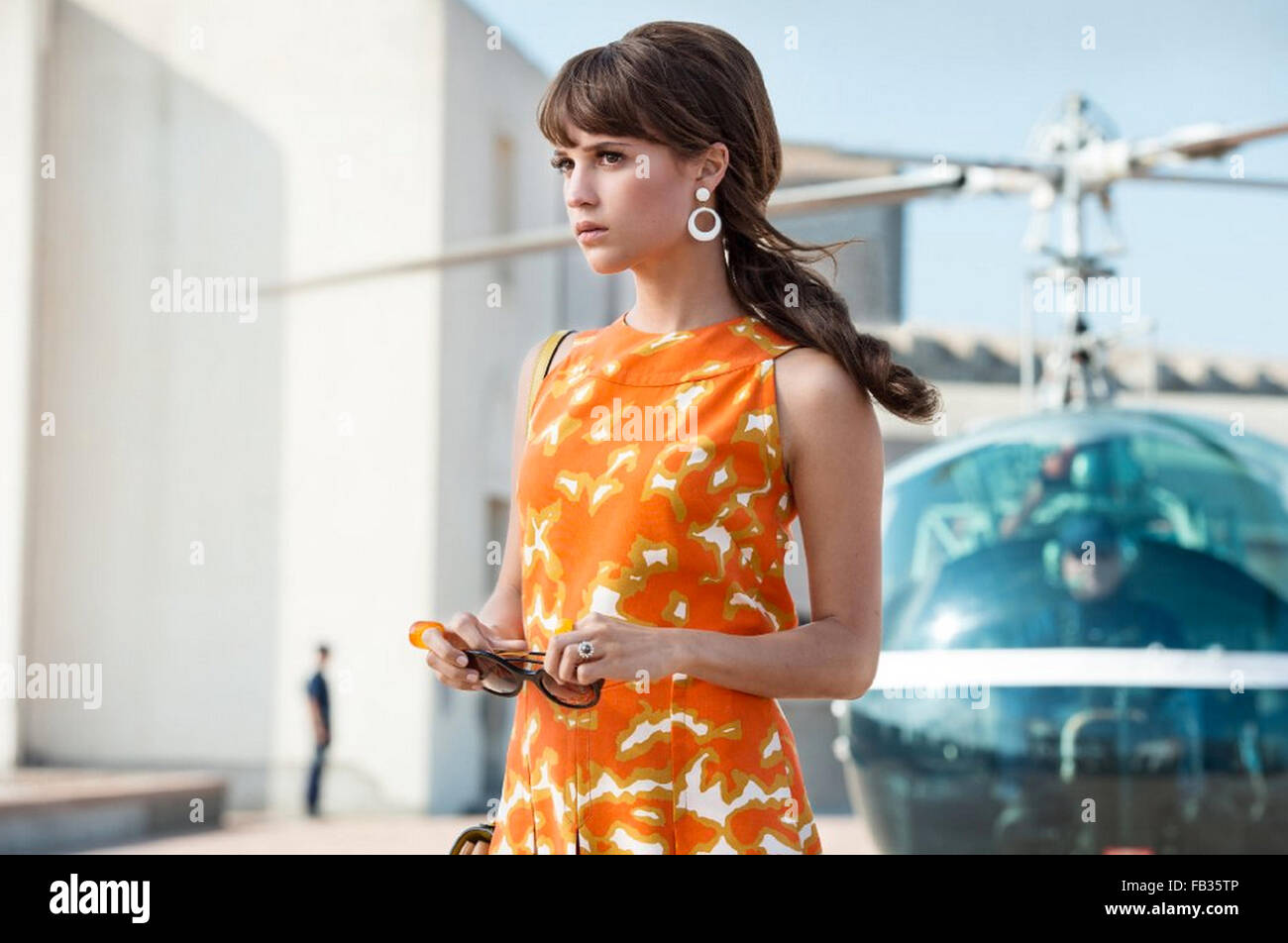 the man from uncle orange dress THE MAN FROM U.N.C.L.E. - 2015 Warner Bros film with Alicia Vikander Stock  Photo