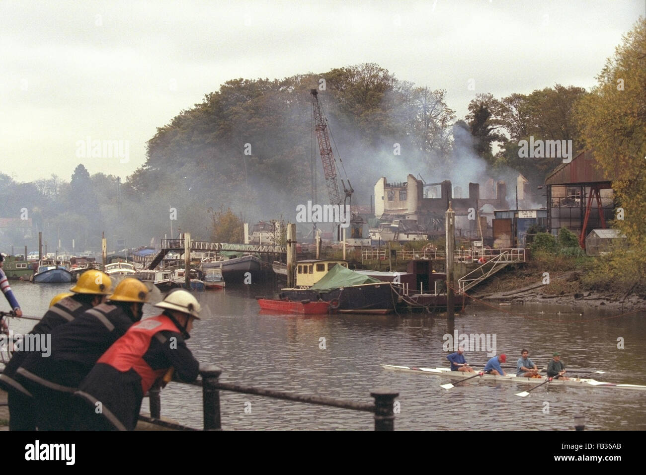 FIREMAN OVERLOOK THE REMAINS OF THE BOAT MARINA WHICH WAS DAMAGED BY