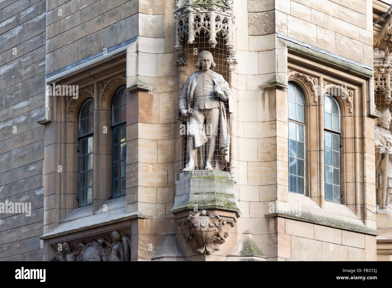 A stone statue on a building at Cambridge University UK Stock Photo Alamy