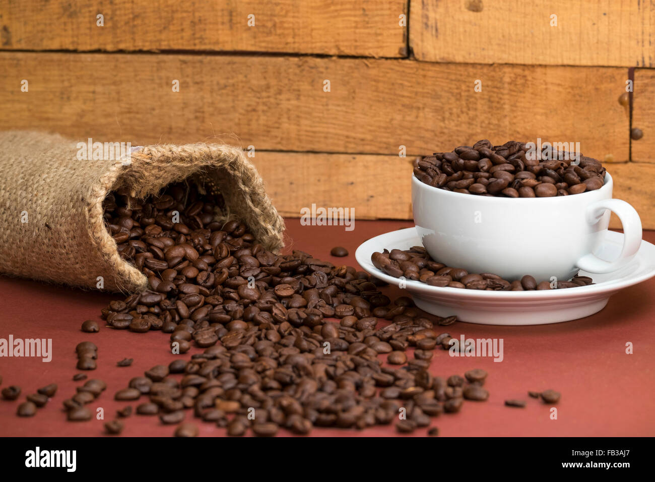 fresh roasted arabica coffee beans cup and saucer hessian sacking