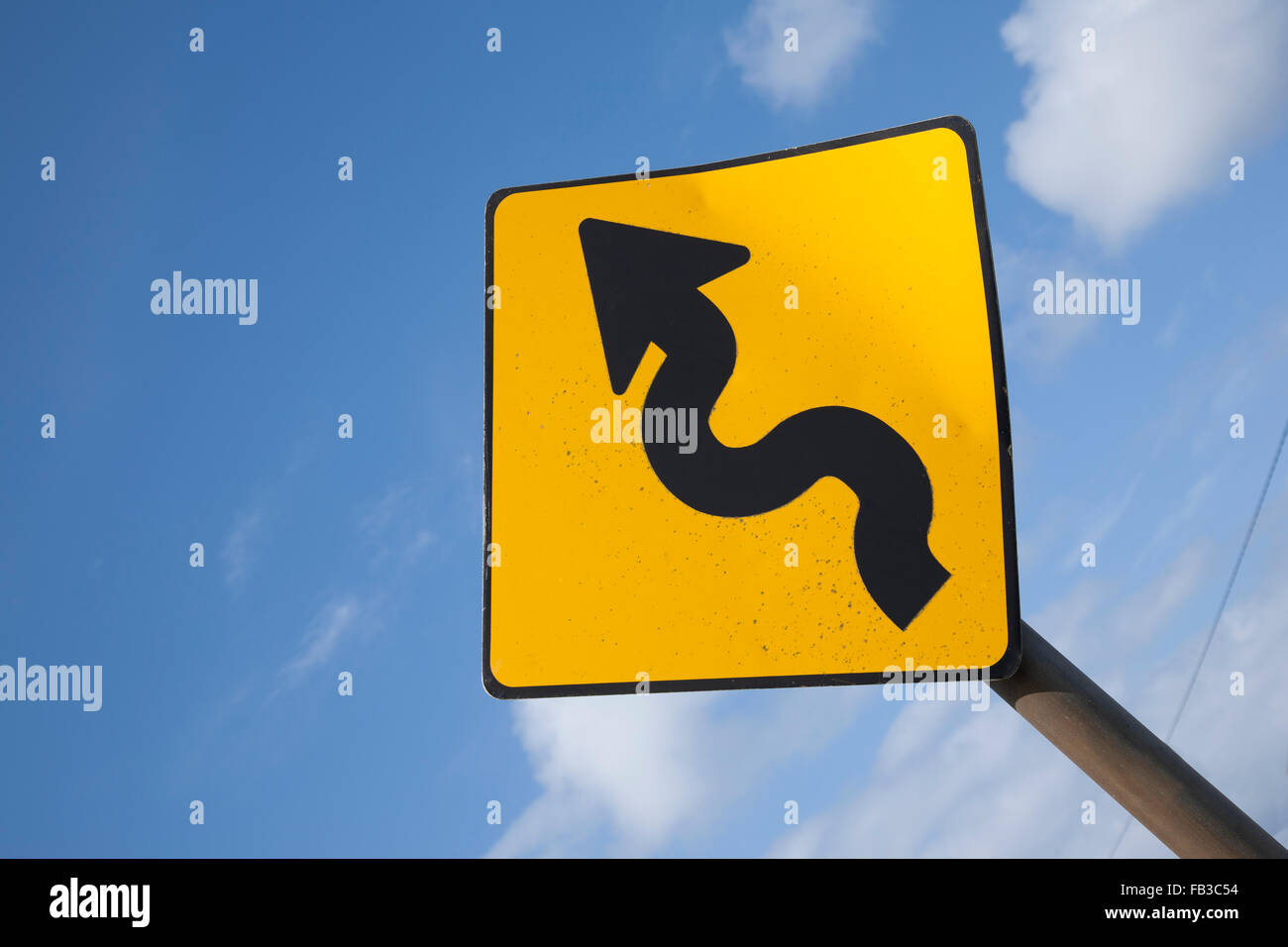 Curve Road Traffic Warning Sign in Village Setting Stock Photo - Alamy