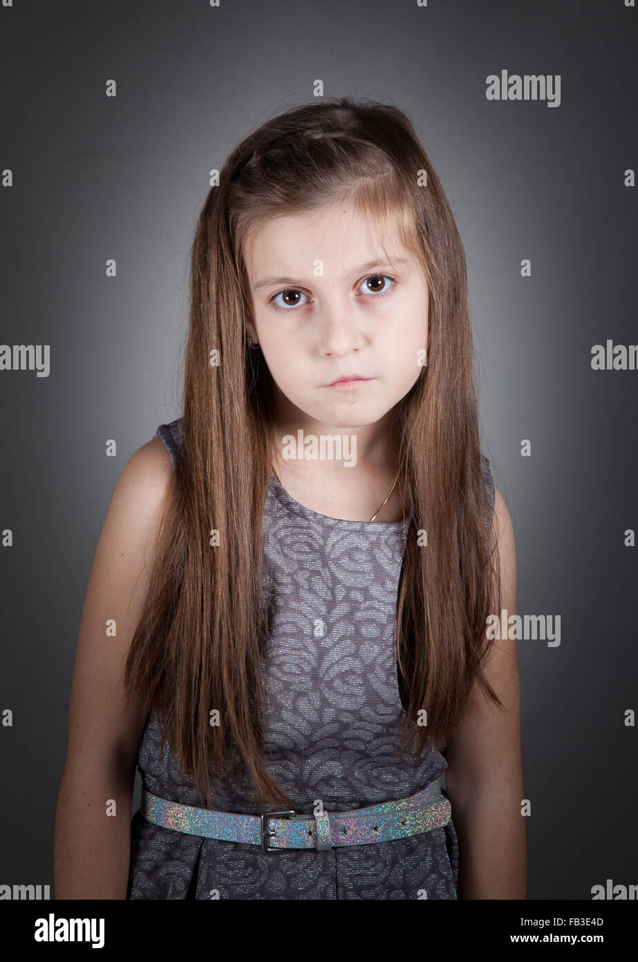 Portrait of a 8 year old girl, nicely dressed, studio shot Stock Photo