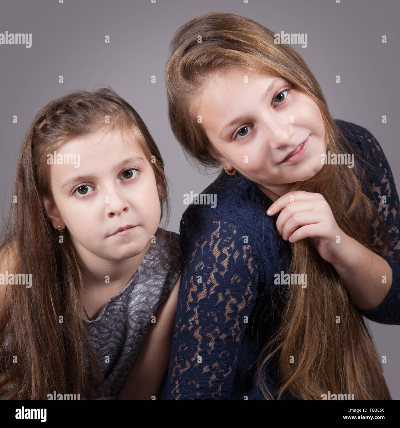 Portrait of8 and 10 year old sisters, studio shot Stock Photo Alamy