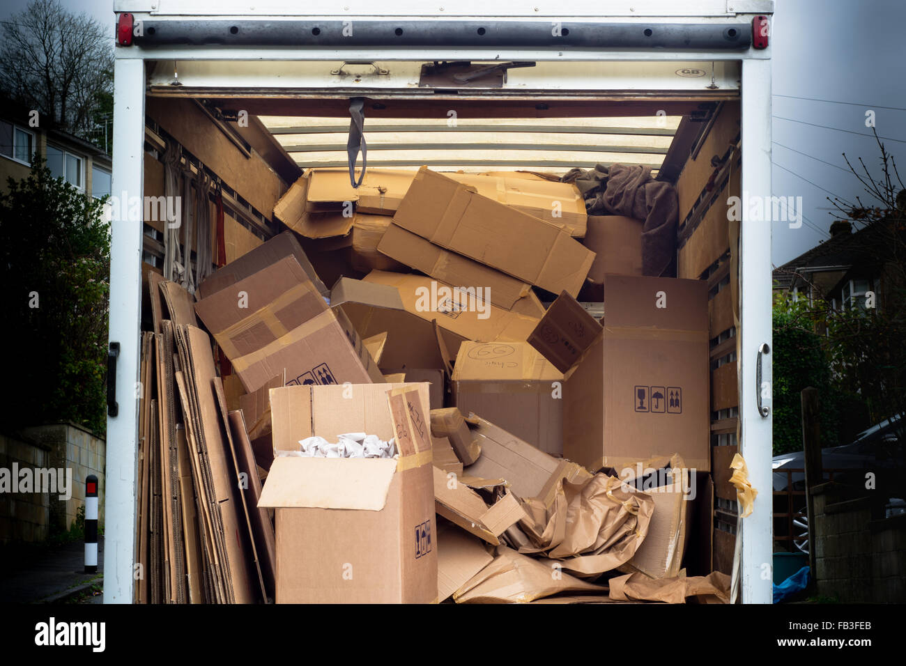 Removal van with untidy boxes dumped inside. A removal lorry is filled