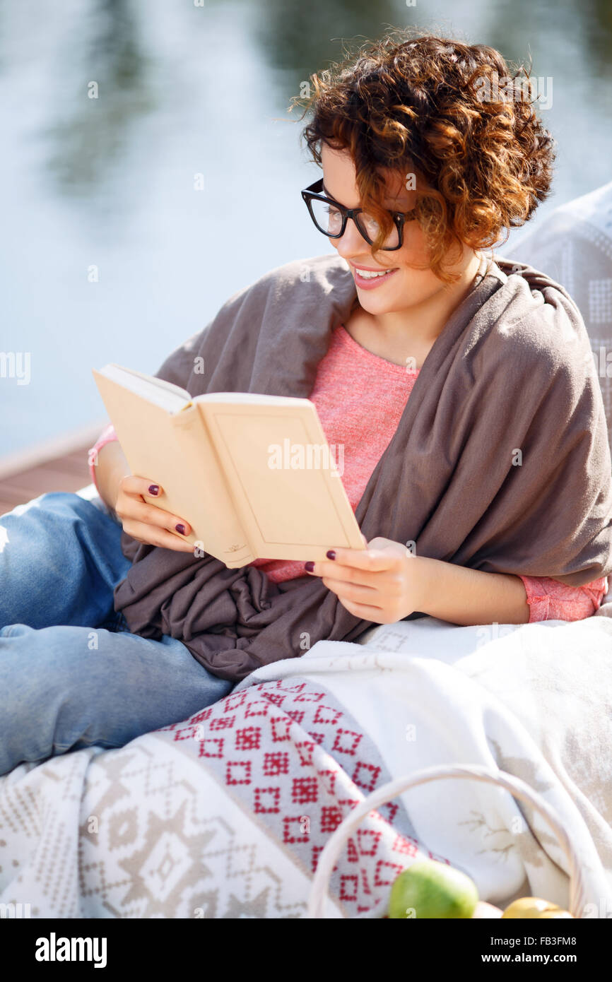 Pleasant girl reading book Stock Photo - Alamy