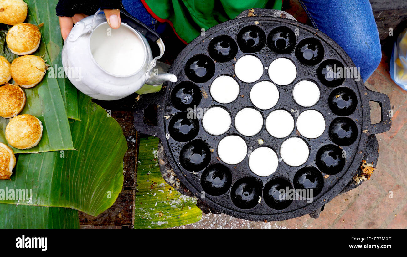 Process of cooking Sweet and Savory Grilled Coconut-Rice Hotcakes, Coconut Rice Cake on banana packaging, Asian dessert, Thai, T Stock Photo
