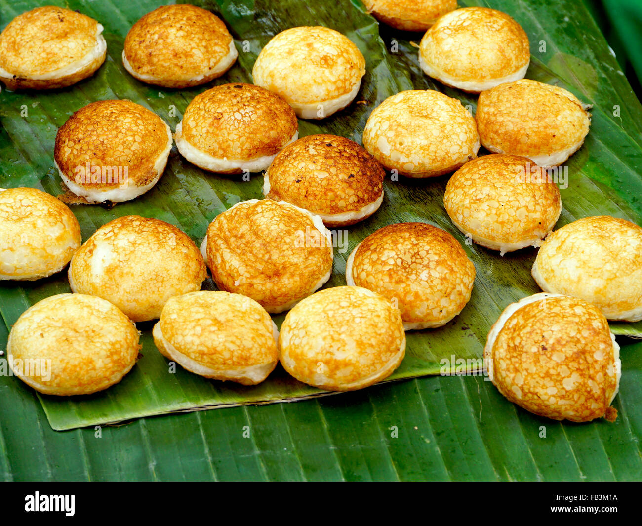 Sweet and Savory Grilled Coconut-Rice Hotcakes, Coconut Rice Cake, Asian dessert, Thai, Thailand, Luang Prabang, Laos Stock Photo