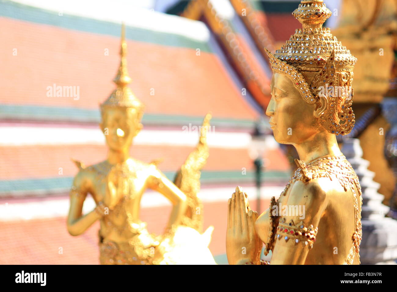 Golden Angel Statue at The Emerald Buddha Temple in Bangkok Stock Photo