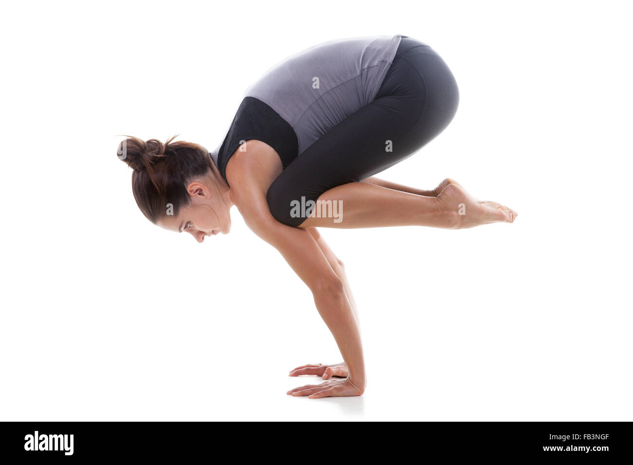 Sporty yoga girl on white background doing handstand Stock Photo