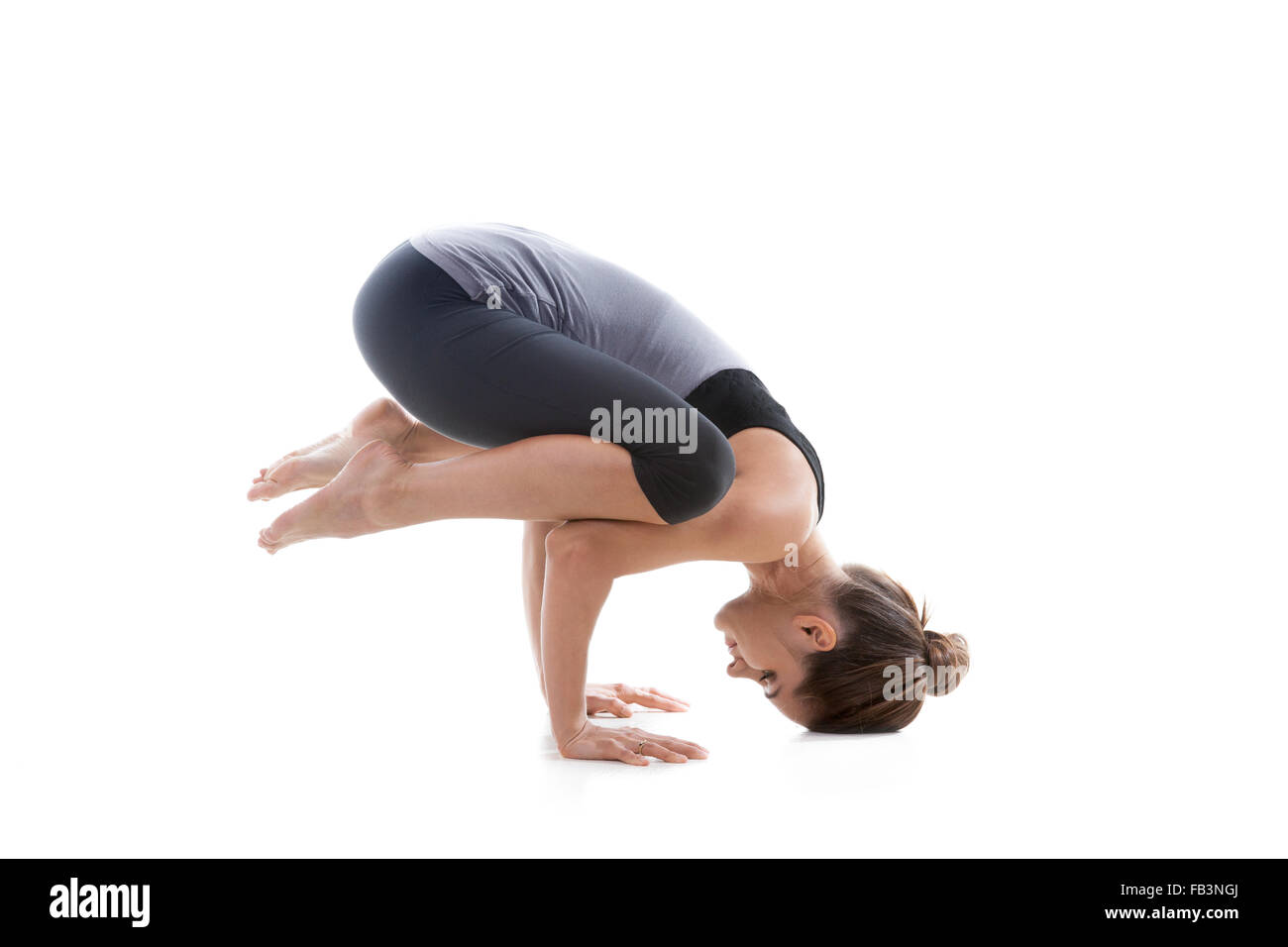Sporty yoga girl on white background exercising Stock Photo