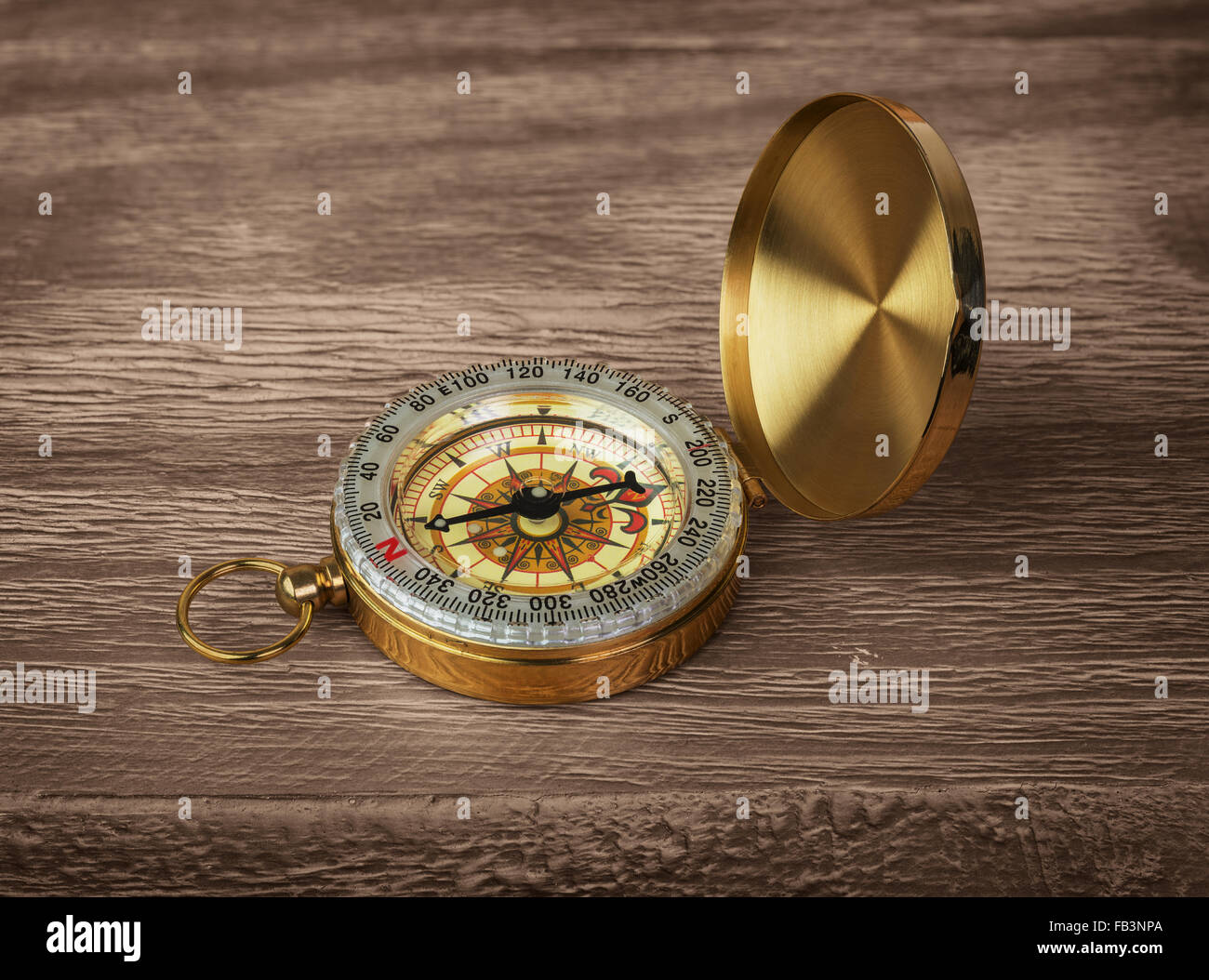 Retro brass compass on a wooden background Stock Photo