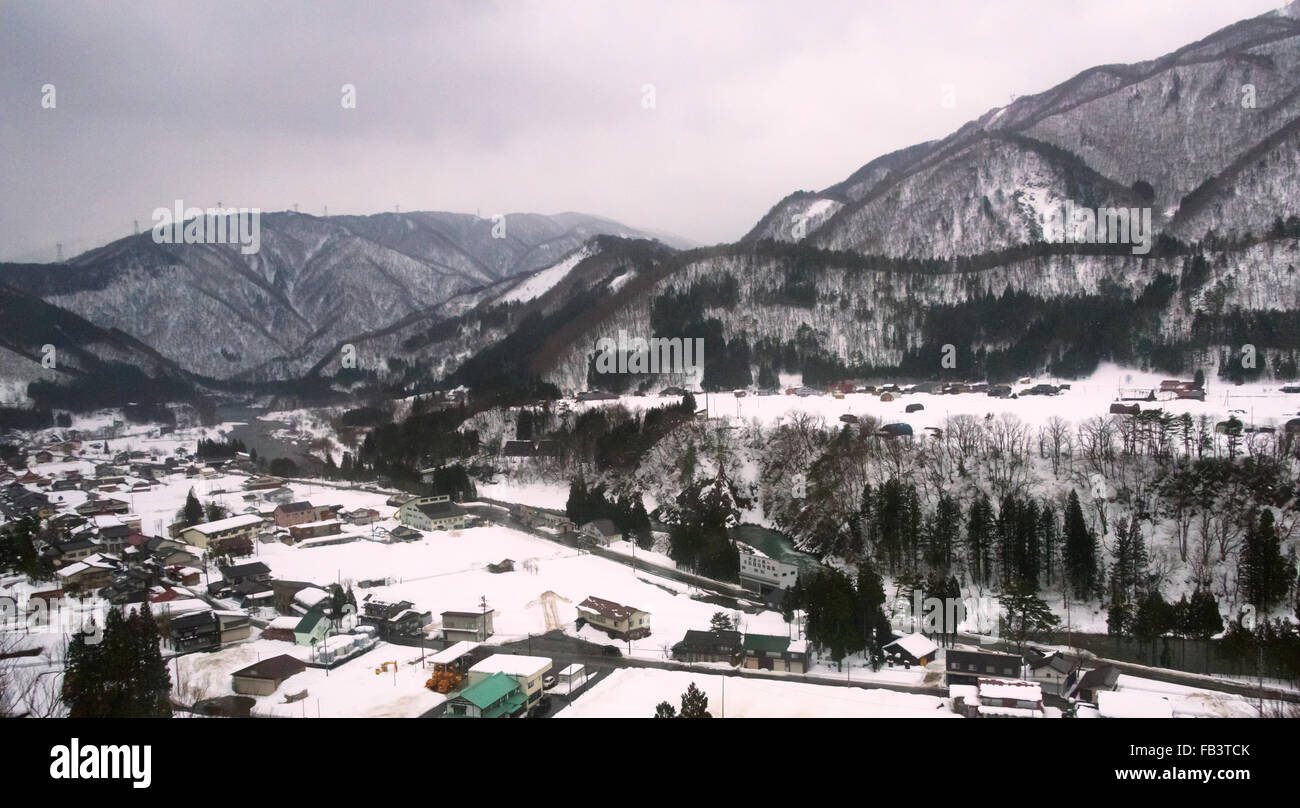 Village at the foot of the mountain covered with snow, Gifu Prefecture, Japan Stock Photo