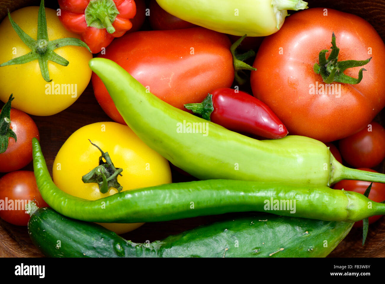 Super fresh garden vegetables after harvest, red and yellow tomatoe, red and green pepper, cucumber, Austria, Vienna Stock Photo