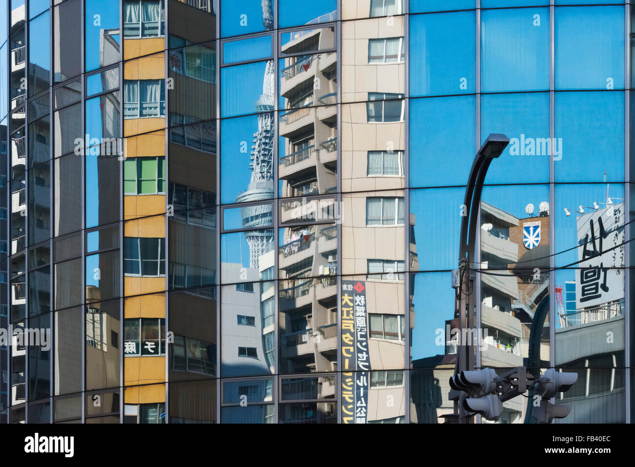 Reflection of buildings on the glass exterior of a building, Tokyo, Japan Stock Photo