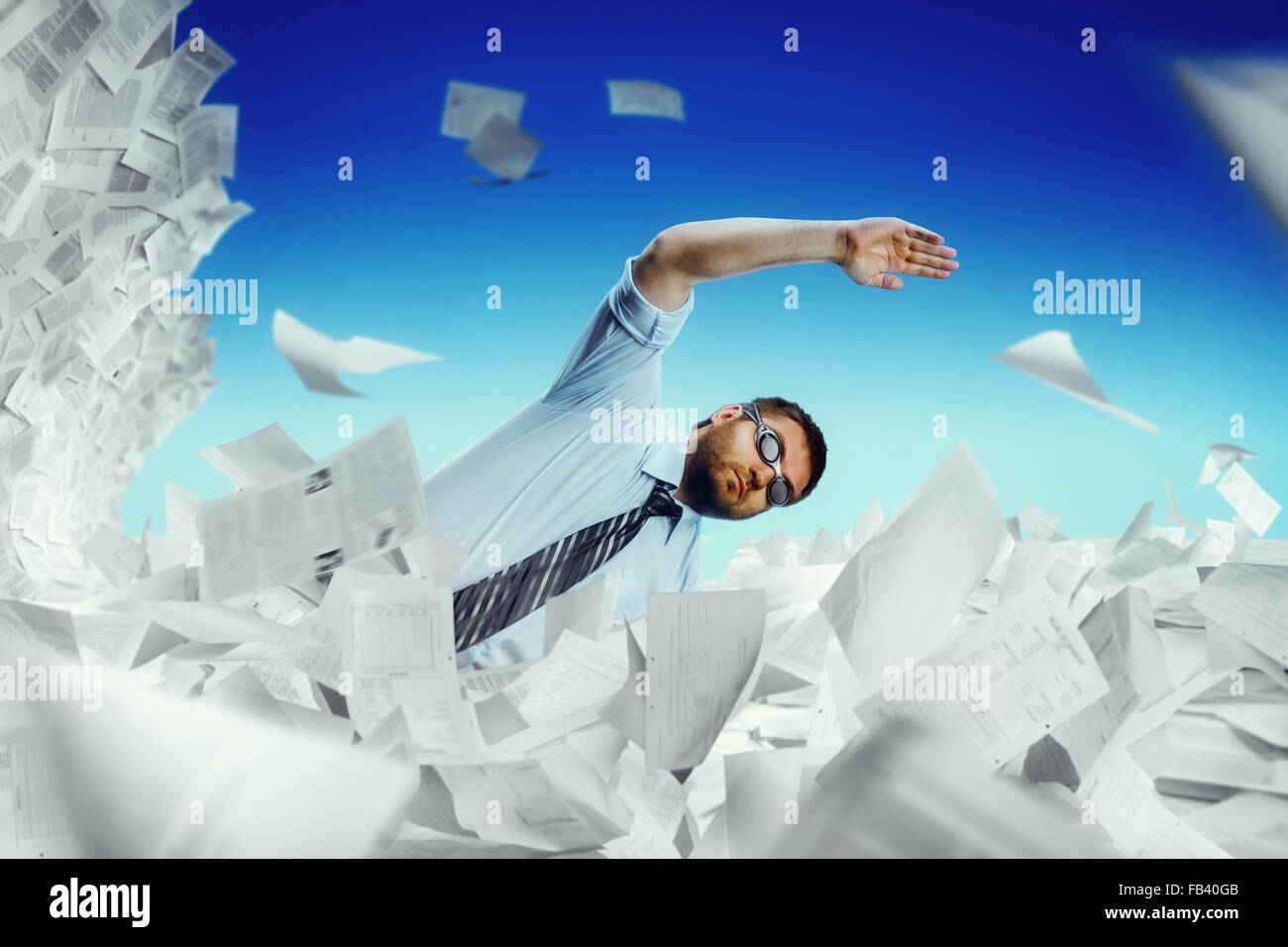 Man swimming in papers Stock Photo