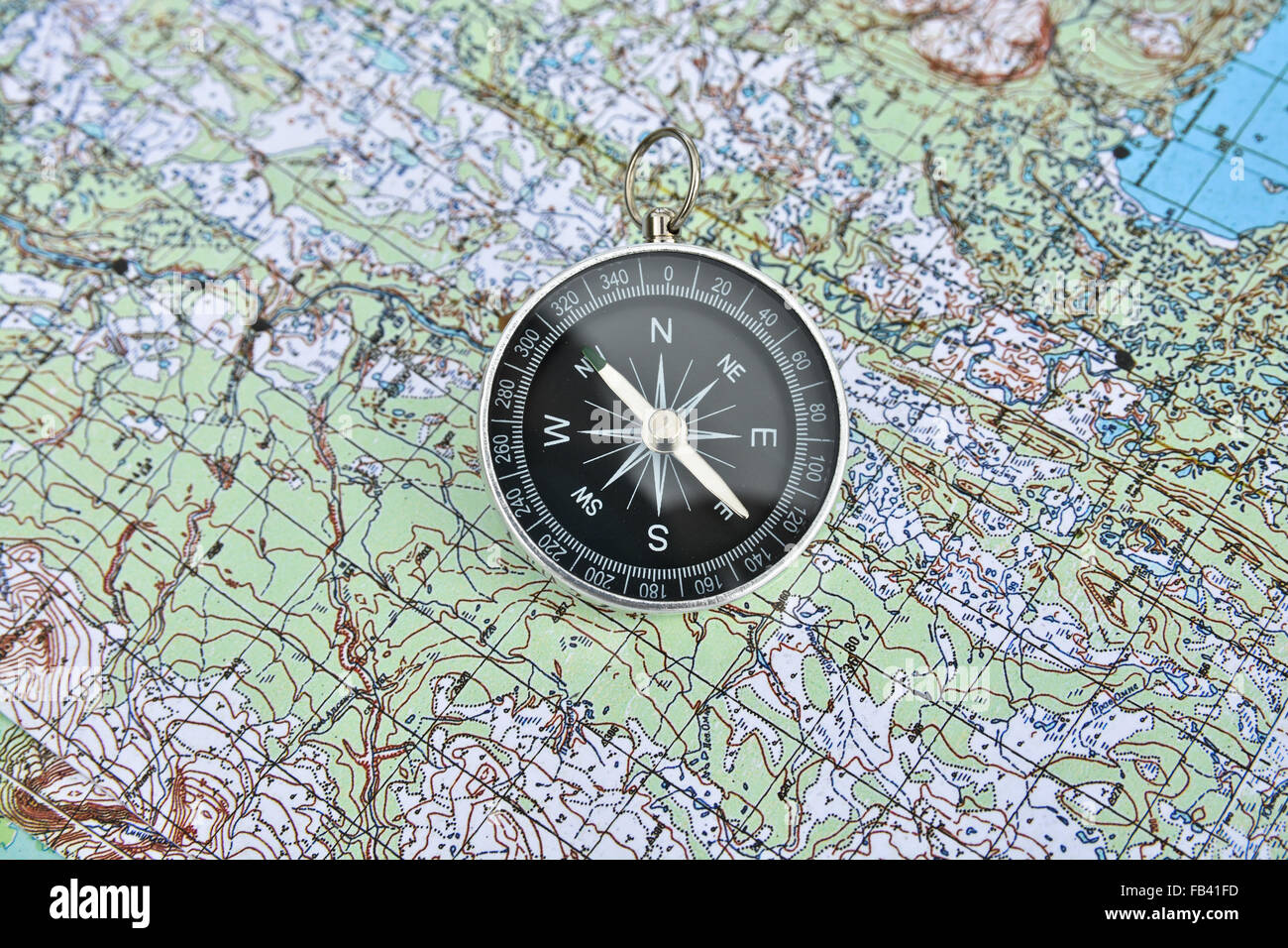 Map and compass. Magnetic compass is located on a topographic map Stock ...