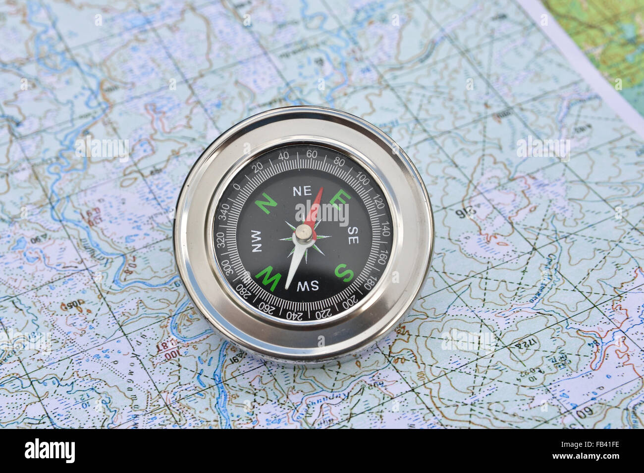 Map and compass. Magnetic compass is located on a topographic map Stock ...
