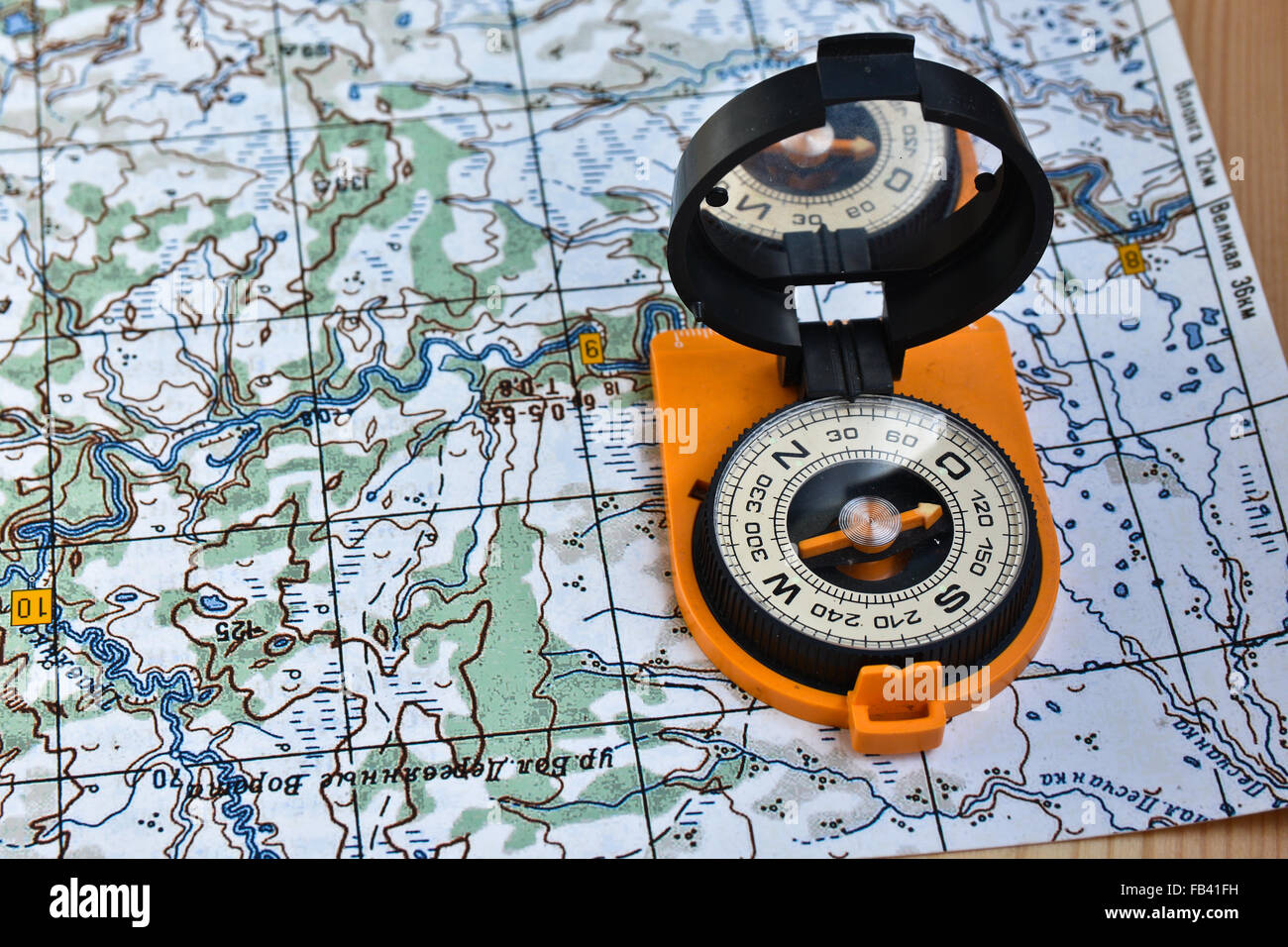 Map and compass. Magnetic compass is located on a topographic map Stock ...