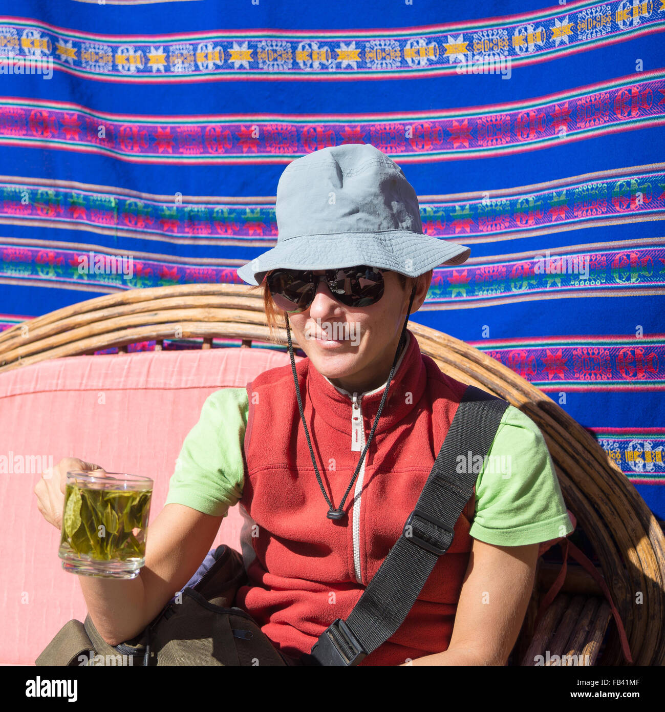 Lady With Sunglasses And Hat Having A Cup Of Coca Leaves Tea Known As lady-with-sunglasses-and-hat-having-a-cup-of-coca-leaves-tea-known-as