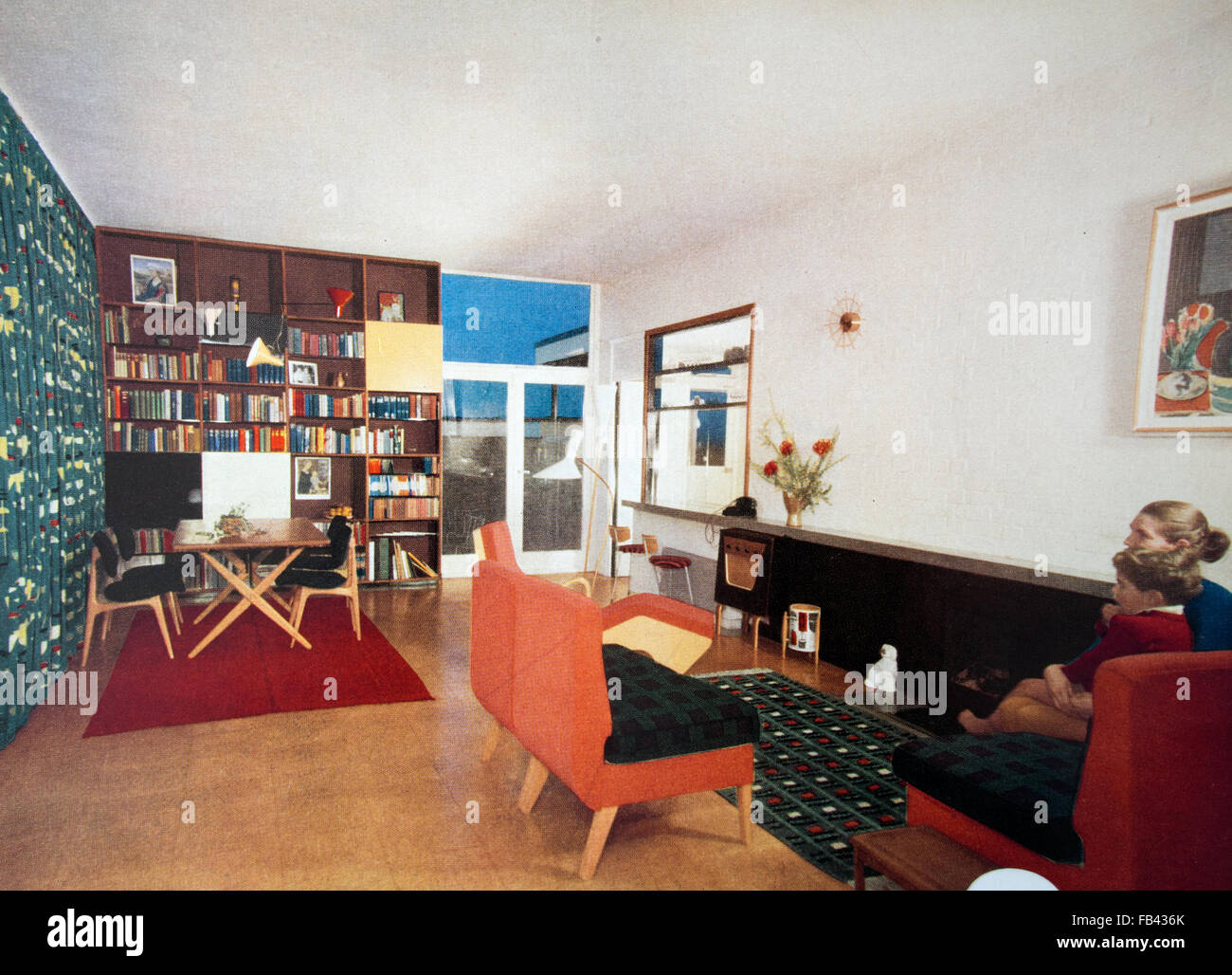 Woman and child, boy, in modern  1950's sitting room. Print from The Book of Good Housekeeping 1957. Stock Photo