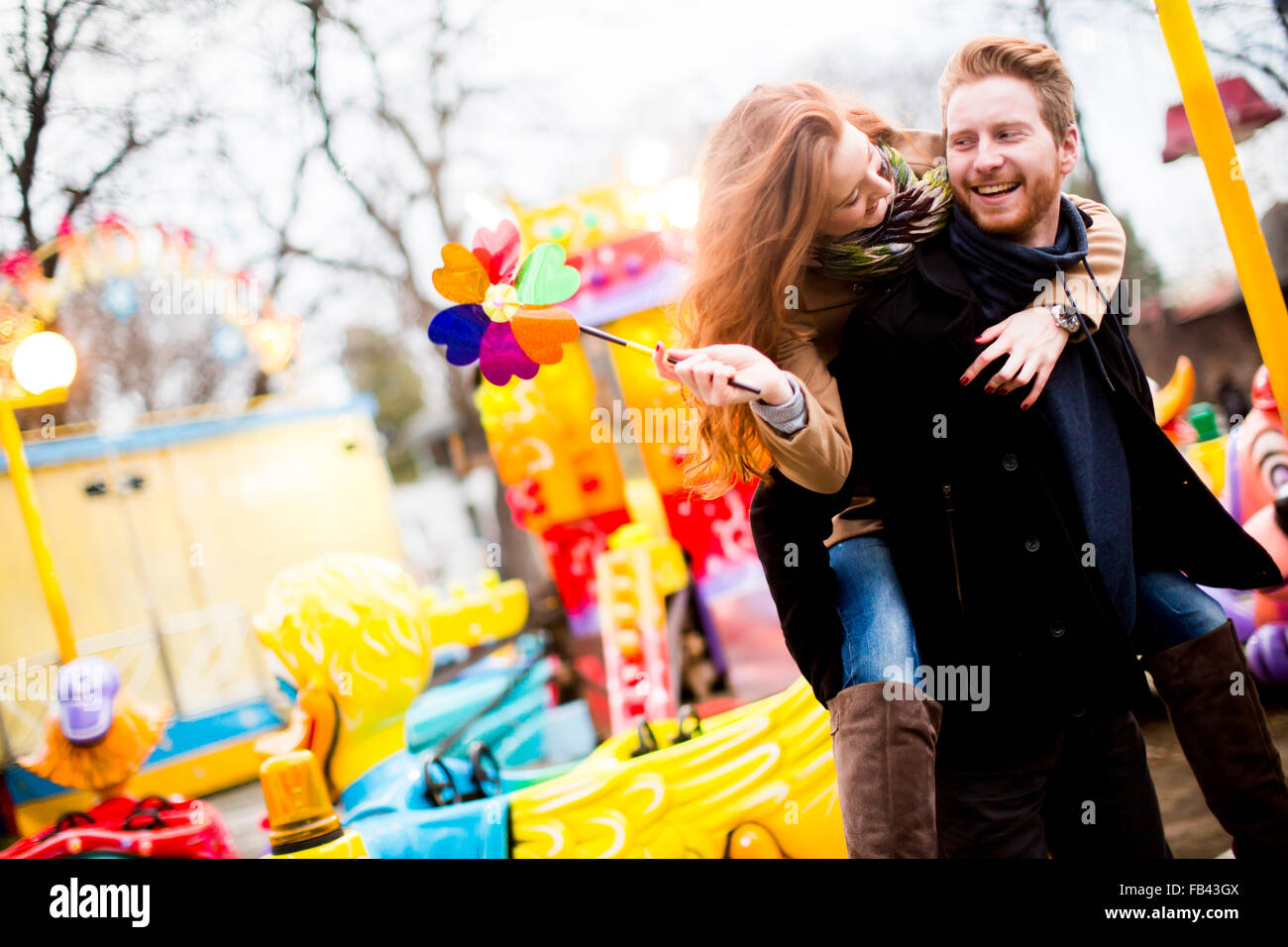 Young couple in the amusement park Stock Photo - Alamy