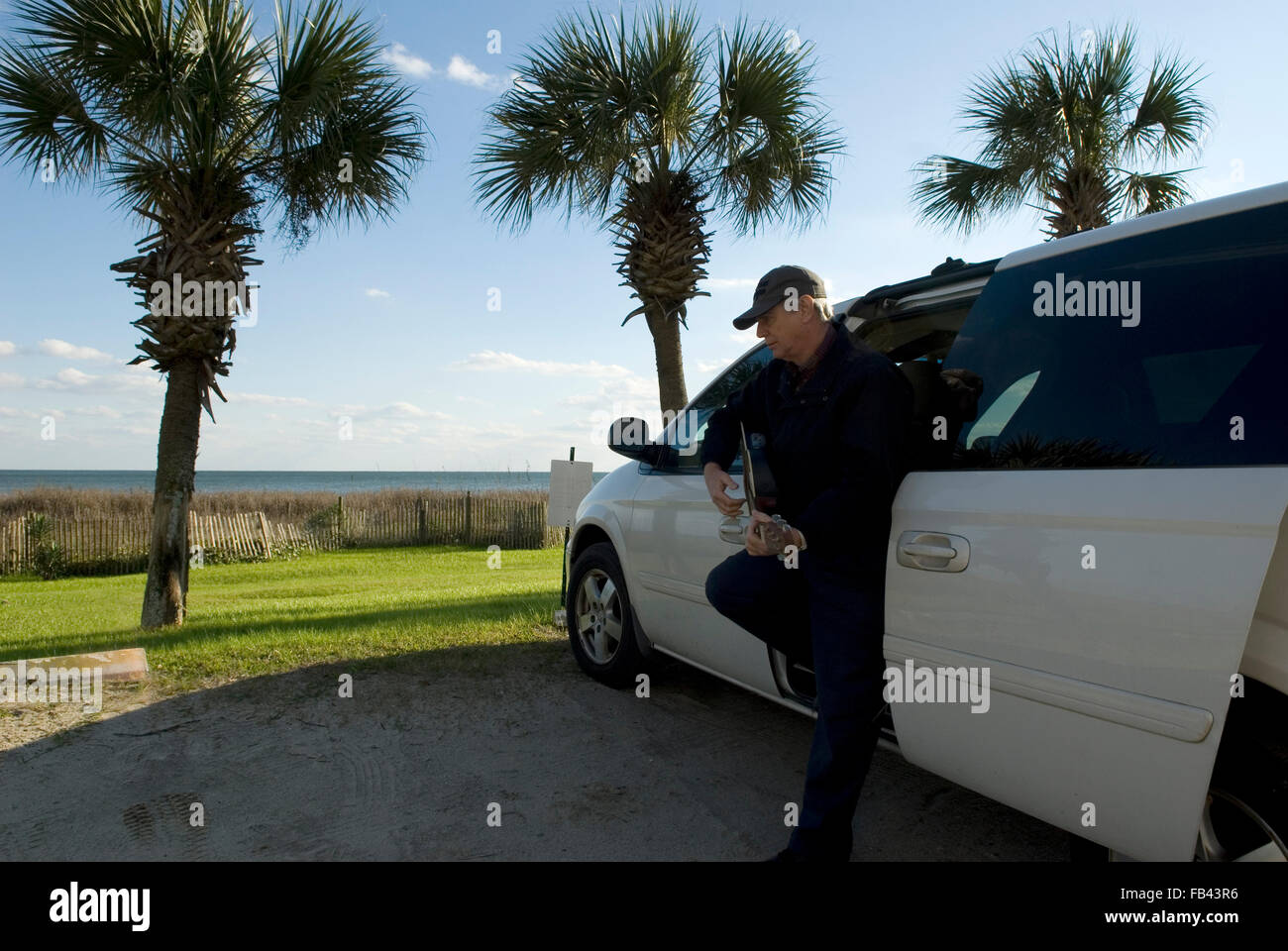 Caucasian man playing guitar by van Myrtle Beach SC USA Stock Photo