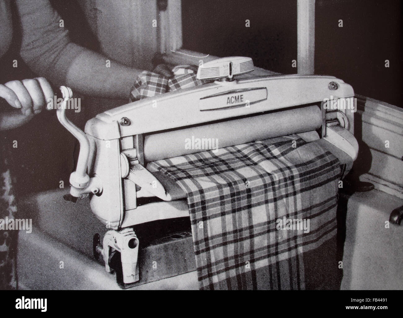 ACME wringer in use, 1957 domestic life. Print from The Book of Good Housekeeping. Stock Photo