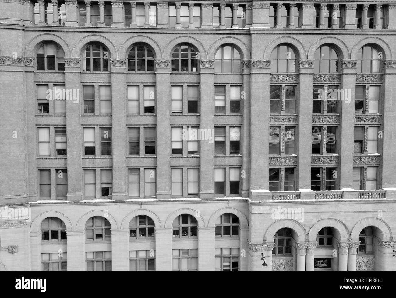 Facade of brick vintage building with arches and windows Stock Photo