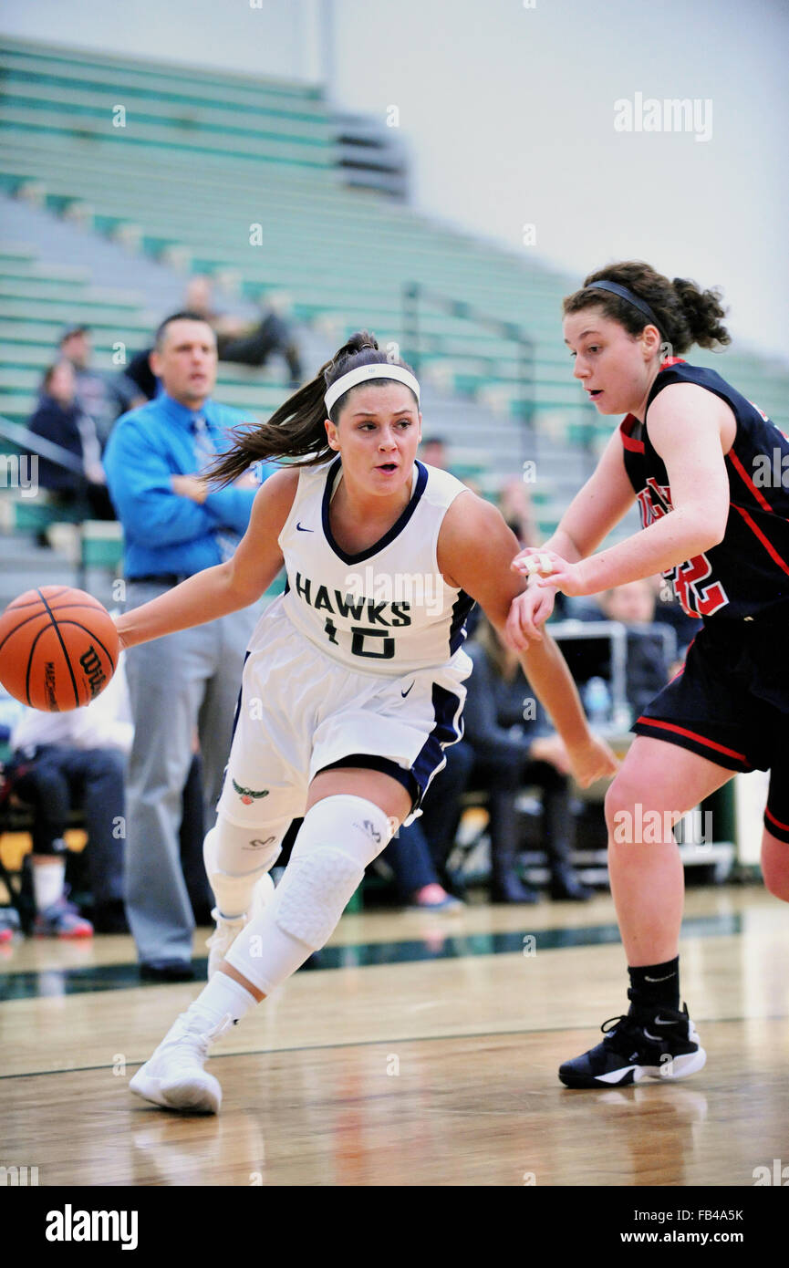 Player protecting the ball as she drives the baseline toward her