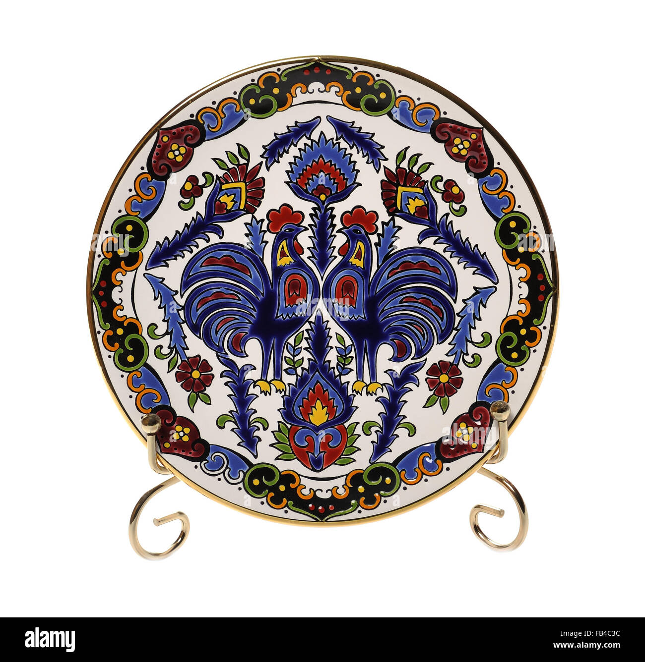 Decorative ceramic plate of hand made trademark 'Faros Keramik' with roosters and ornamet Stock Photo