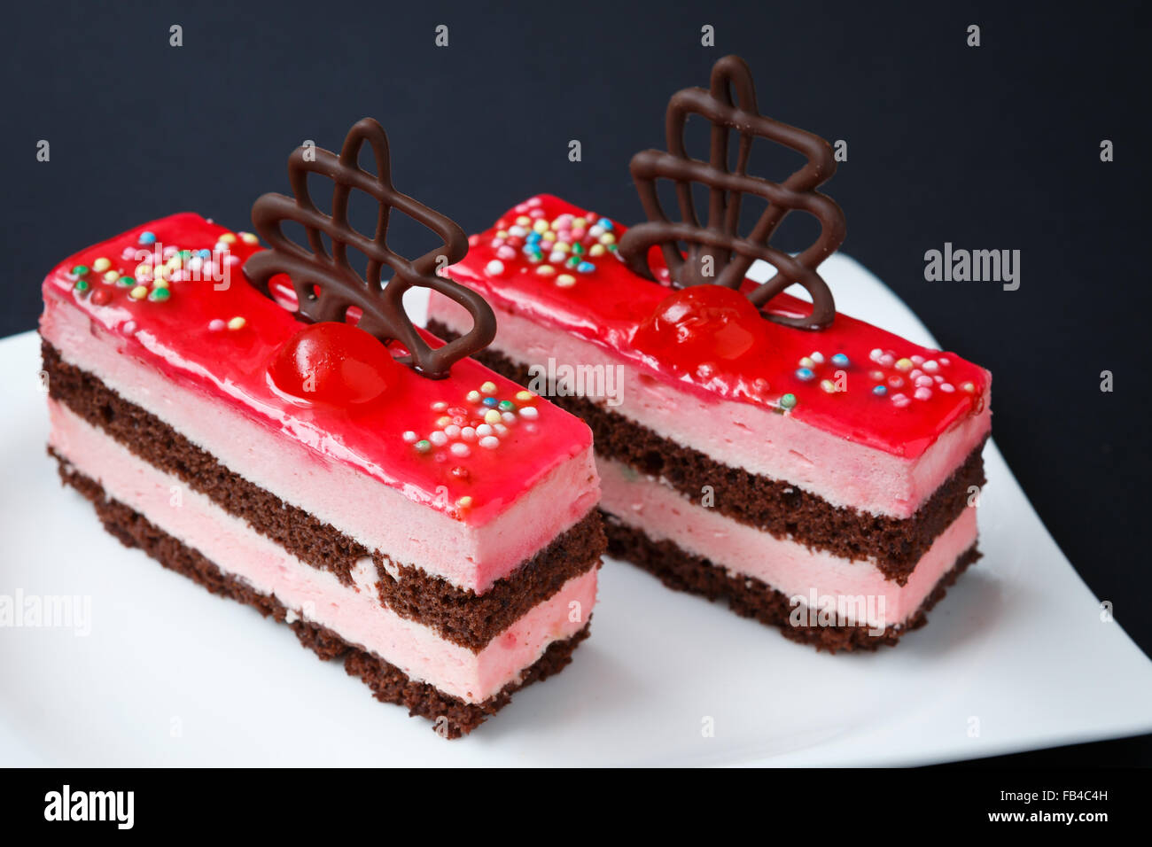 Sweet colorful desserts on a black background Stock Photo - Alamy