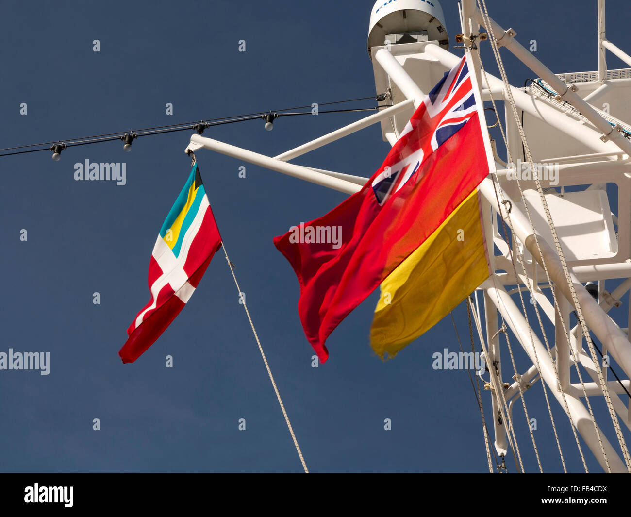 Ms Hanseatic flying yellow quarantine flag, UK red and Bahamas ensigns and Hapag Lloyd flags Stock Photo