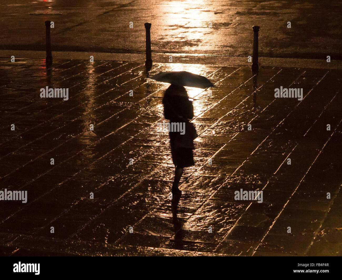 Walking through London in the rain at night Stock Photo