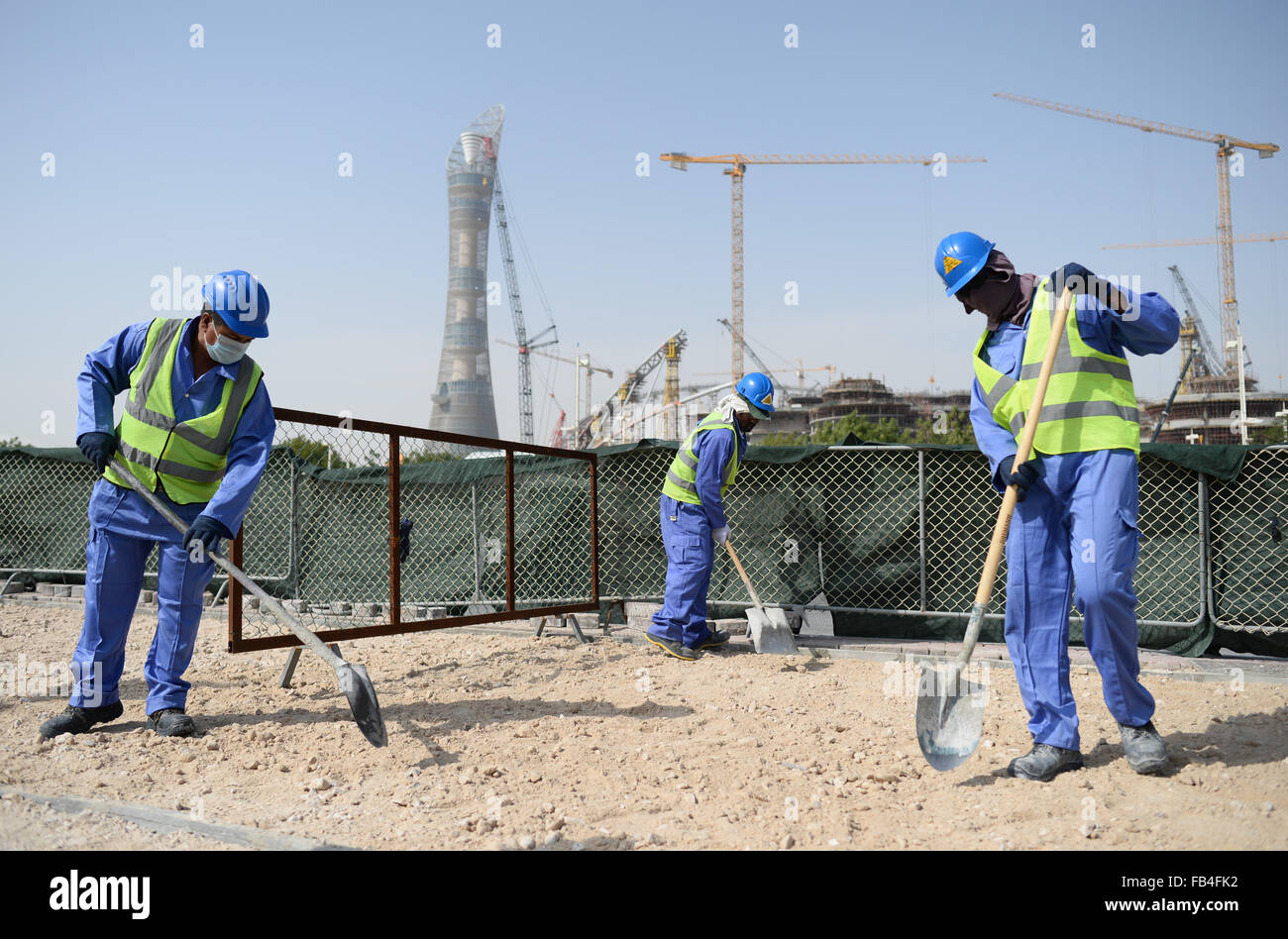 Construction workers from Sri Lanka work at a construction site in
