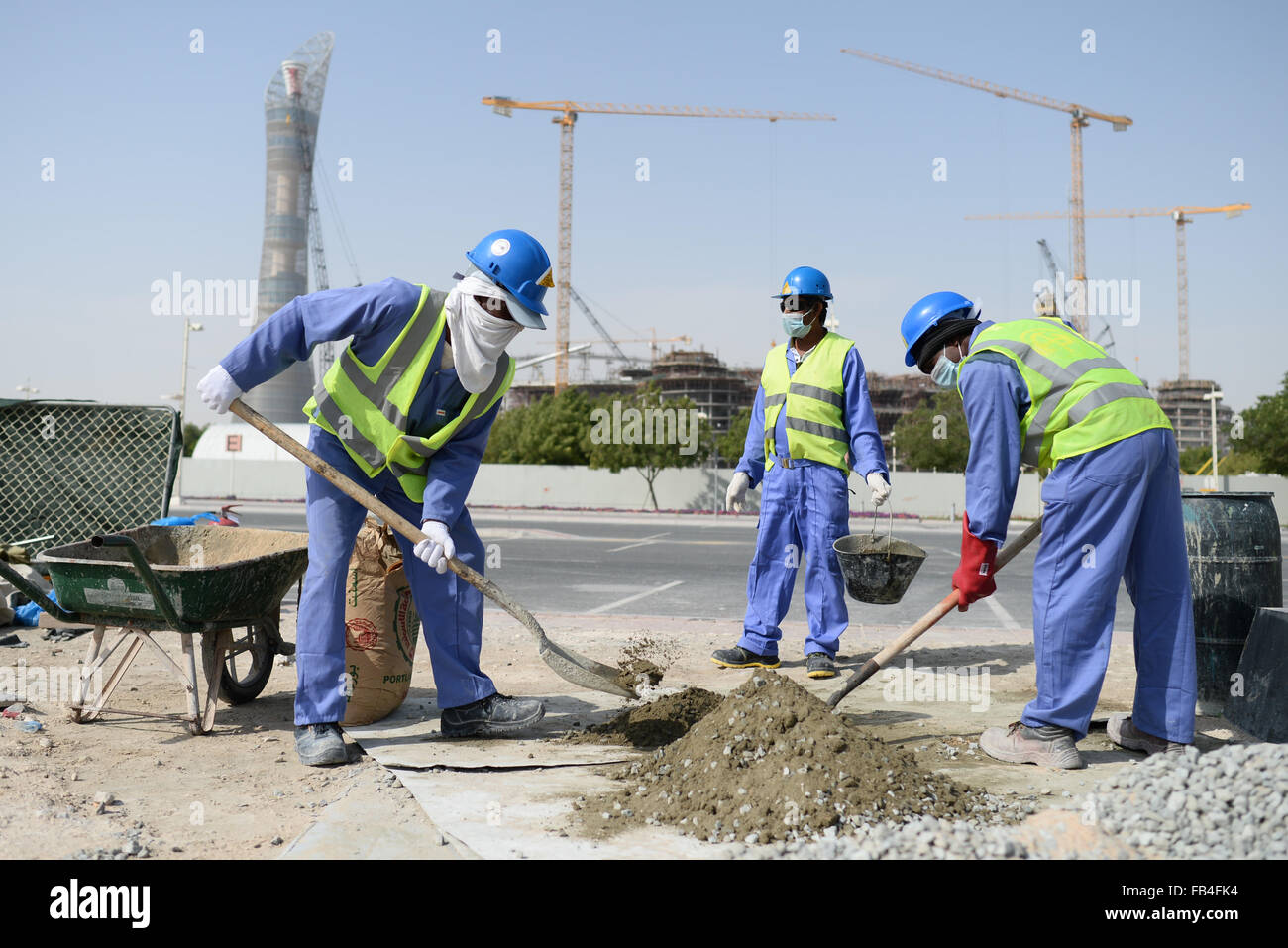 Construction workers from Sri Lanka work at a construction site in