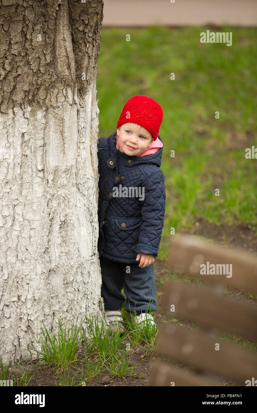 cute little girl playing in the park in spring Stock Photo - Alamy