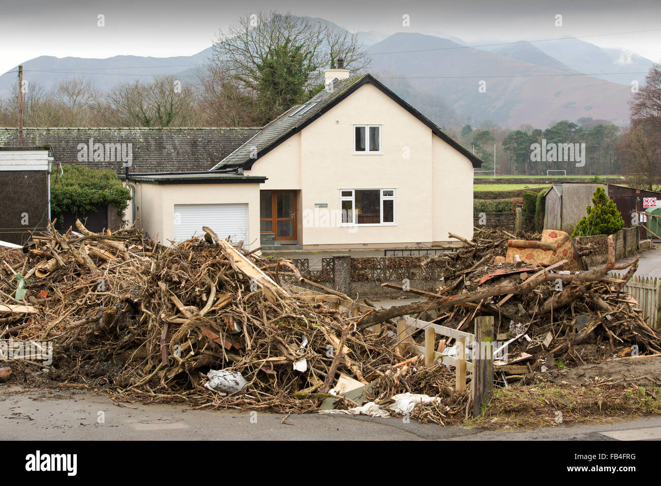 On Saturday 5th December 2015, Storm desmond crashed into the UK, producing the UK's highest ever 24 hour rainfall total at 341.4mm. It flooded many towns including Keswick. This shots shows piles of flood debris in Keswick from the flooding River Greta, which overtopped the new flood defences, built after the 2009 floods. Stock Photo