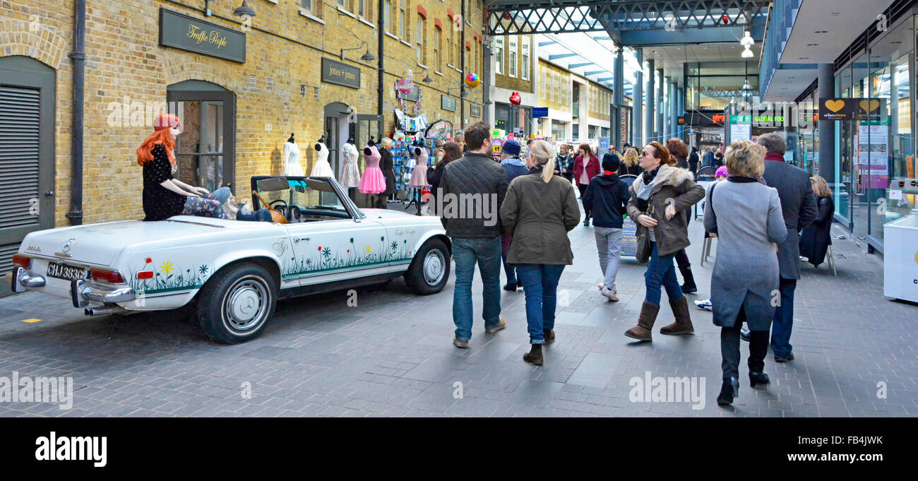 Mannequin sitting on old Mercedes convertible car parked outside the Traffic People boutique adjacent to Spitalfields covered market London England UK Stock Photo