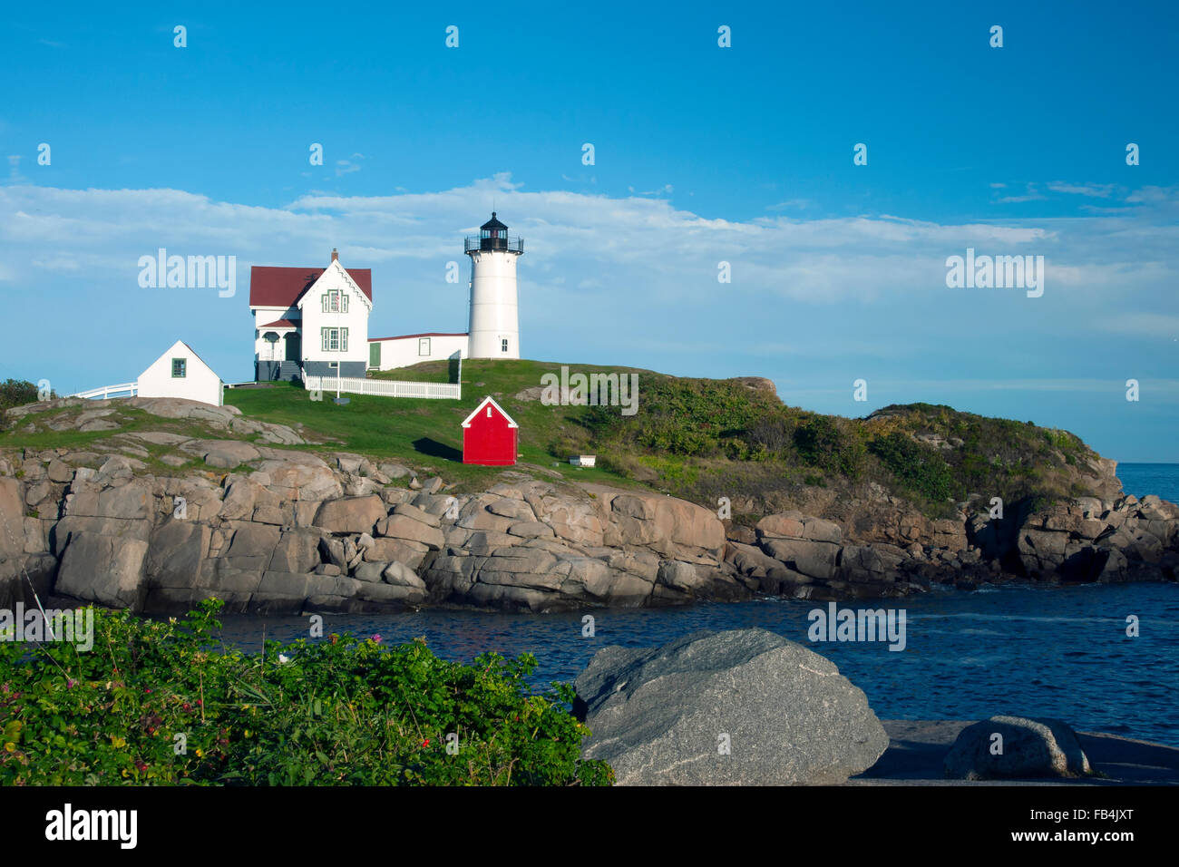 Cape Neddick lighthouse, also known as Nubble light, is a popular attraction on a peaceful summer day. It lies a few hundred feet from the mainlan. Stock Photo