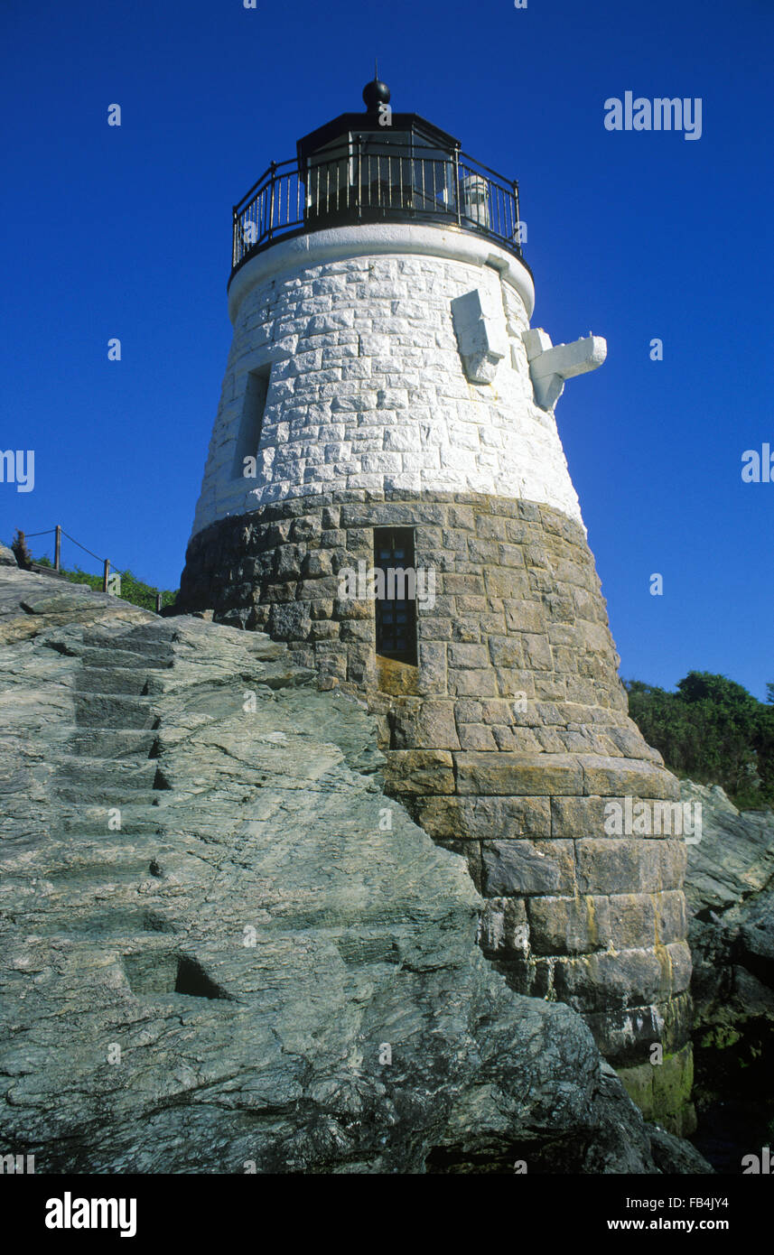 Steps are carved out on rock ledge by Castle Hill lighthouse as the beacon itself is a unique stone structure in Newport, Rhode Island. Stock Photo