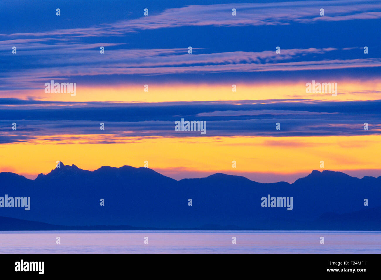 sunrise over coastal mountains seen from Vancouver Island, British Columbia, Canada Stock Photo