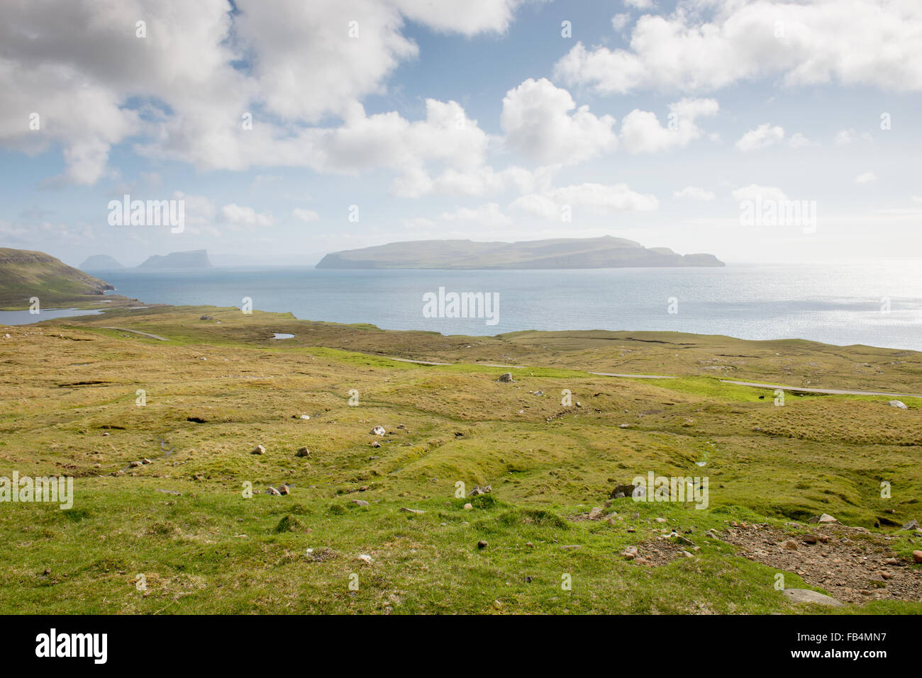 Typical landscape on the Faroe Islands, with green grass and rocks on Sandoy close to Sandur Stock Photo