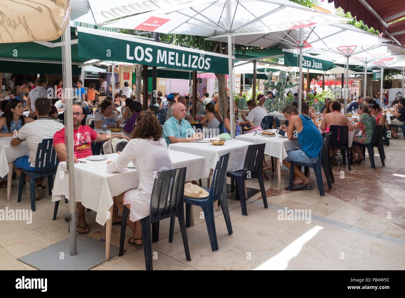 Carihuela, Spain-August 23rd 2015: People eating lunch in a busy restaurant. Carihuela is a beach resort in Torremolinos. Stock Photo