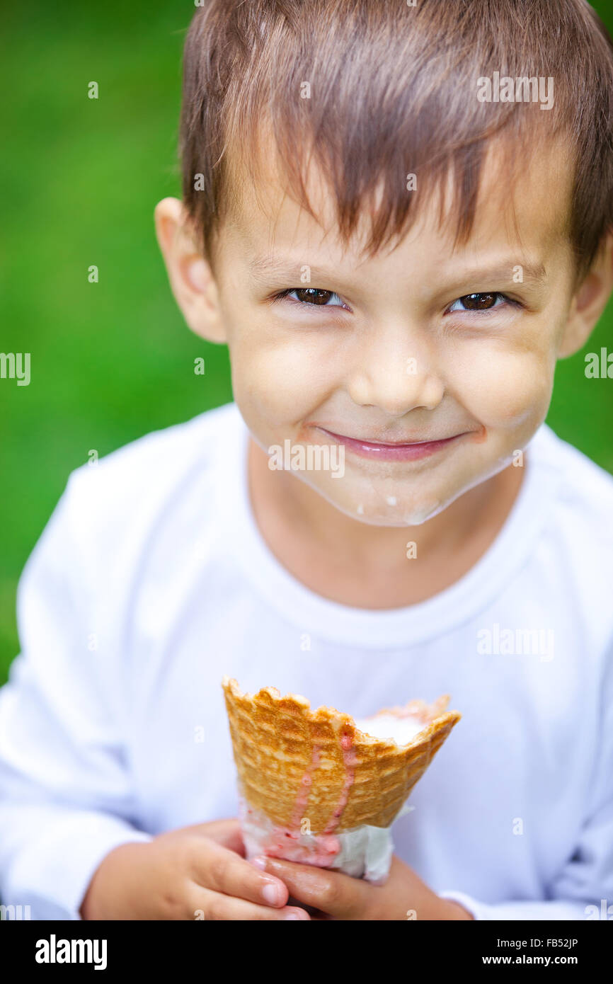 Portrait of young kid eating a tasty ice cream outdoor Stock Photo Alamy