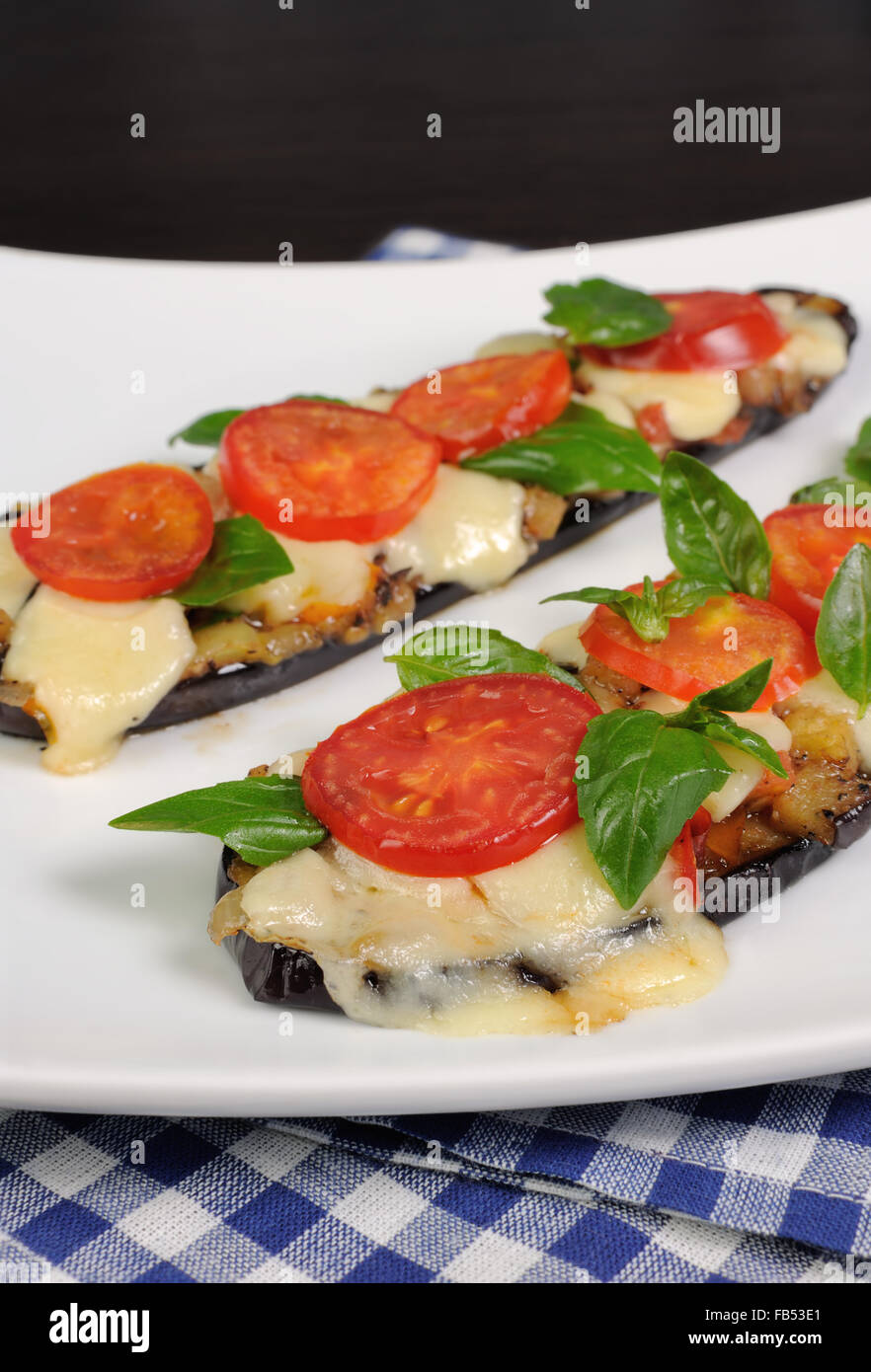 Sliced eggplant baked with tomato and basil and cheese Stock Photo Alamy