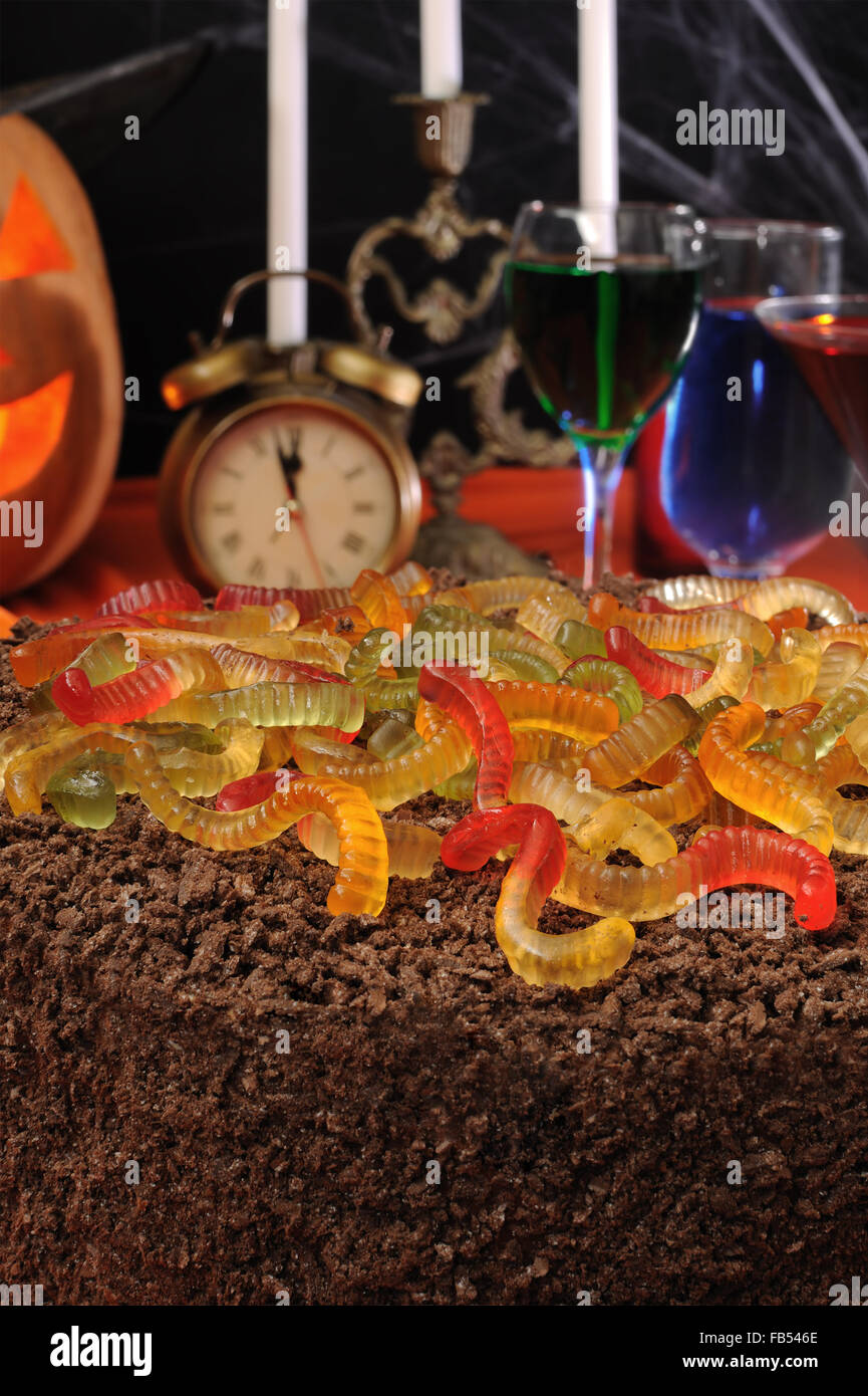 Chocolate cake with gelatin worms on the festive table in honor of
