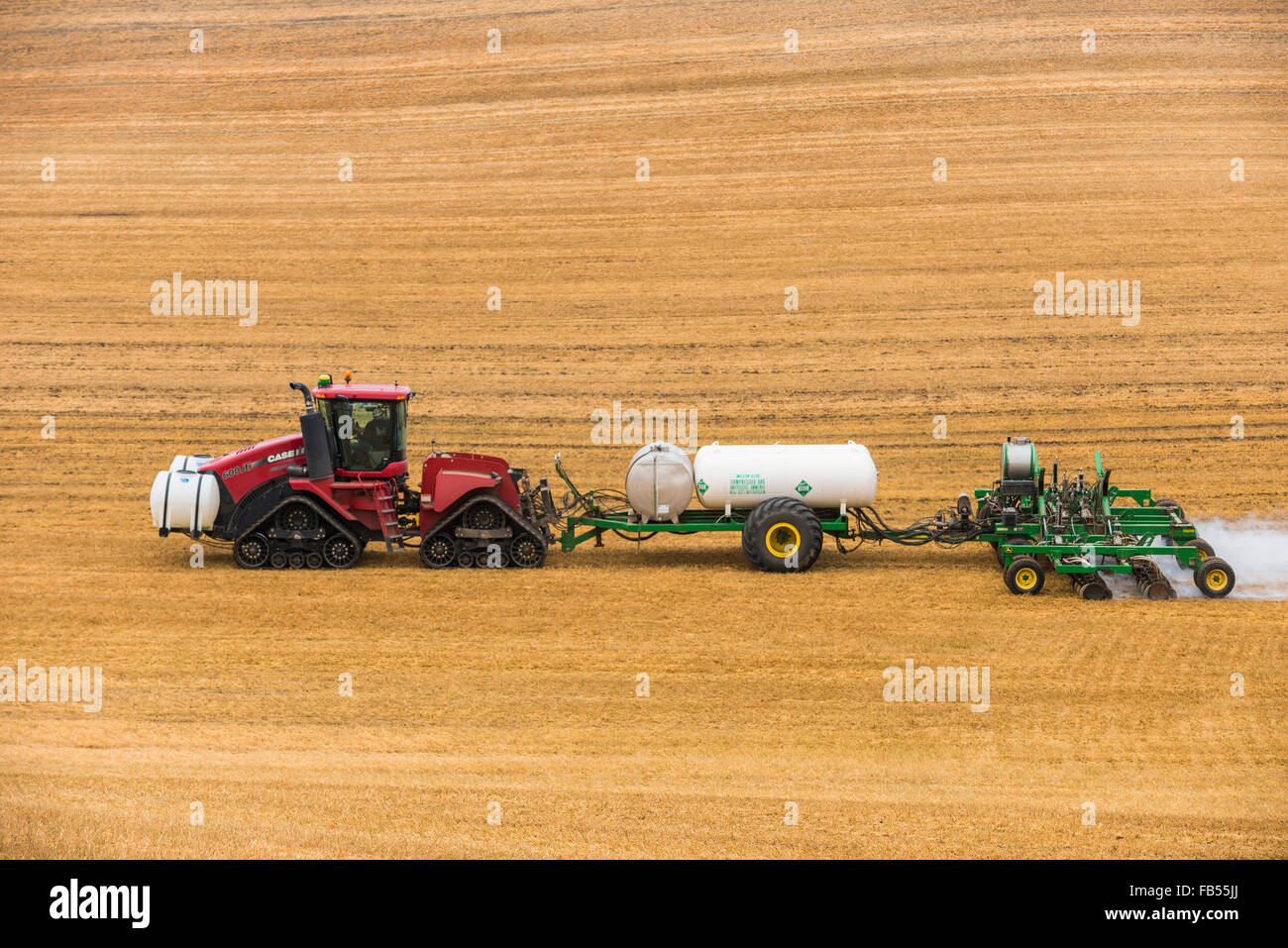 Case quadtrac tractor pulling an anhydrous ammonia tank and applicator